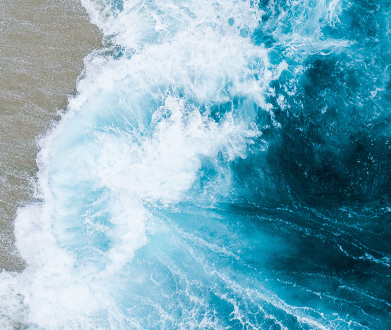 waves crashing against the beach sand